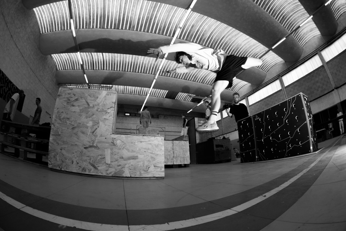 Parkour athlete vaulting over obstacles at AeroJam 2025