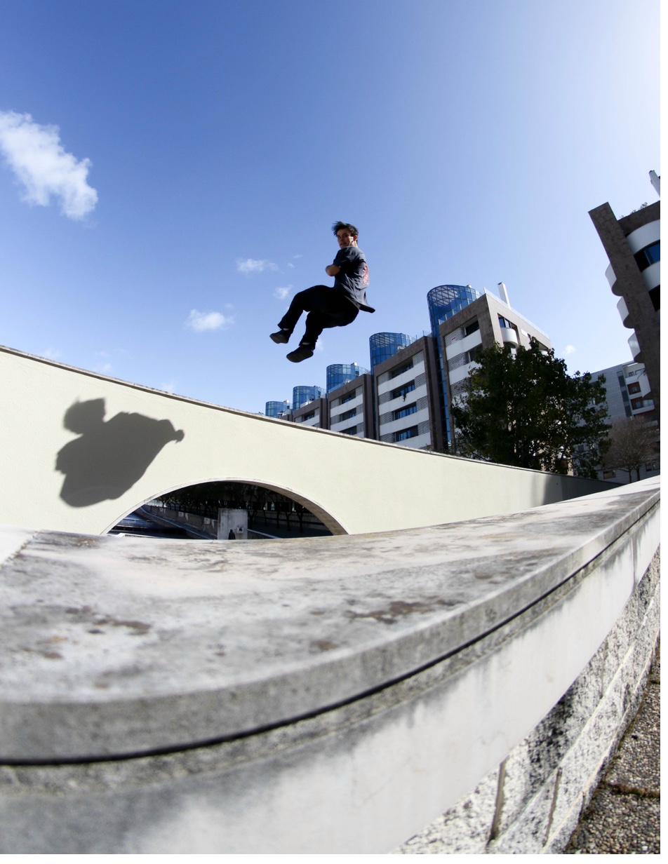 Parkour athlete performing a dynamic jump, captured in cinematic light